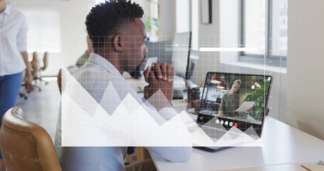 Image of financial data processing over african american businessman using laptop for image call