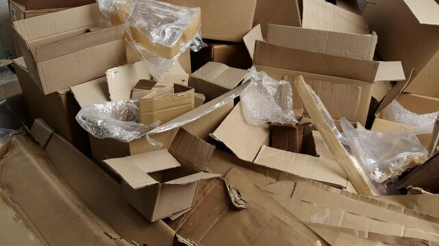 Cardboard and film waste. Used shipping boxes. Sheets or stiff multi layered papers that have been used, discarded or regarded as waste