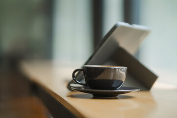 Digital Detox: A moment of calm - a steaming cup of coffee sits invitingly beside a tablet, embodying the balance between work and relaxation in today's connected world. 