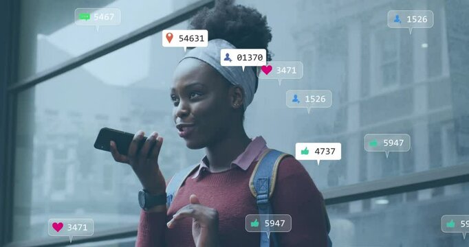 Animation of icons and data processing over african american woman using smartphone