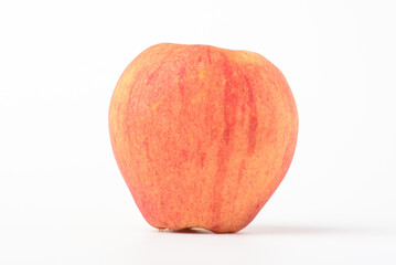 Fresh ripe apple with tiny water drops on white background