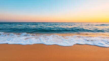 Obraz premium A serene beach scene at sunset, featuring gentle waves lapping against soft golden sand under a clear sky.