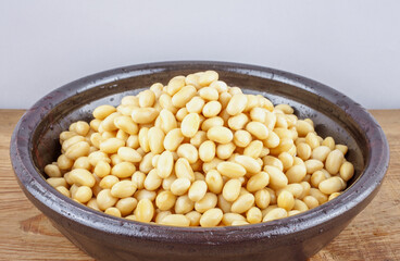 Raw soybeans soaked in water on a brown jar, South Korea 