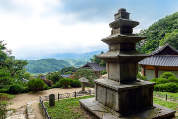 Yeongju-si, Gyeongsangbuk-do, South Korea - June 27, 2019: Three-story stone pagoda with the background of Muryangsujeon Hall at Buseoksa Temple