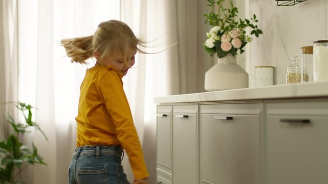 Happy little girl dancing dancer fun rhythmically moving hobby entertainment holidays preschool child daughter music pastime kid schoolgirl childish active smile home weekend preteen jumping energetic