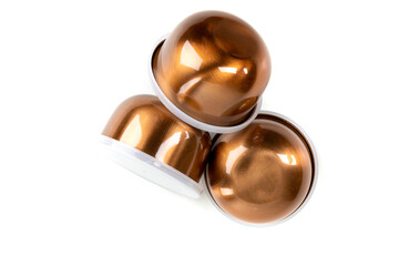 Three copper bowls with lids jumbled near each other over white