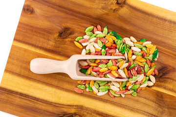 Scoop of roasted salted colored pumpkin seeds on a cutting board