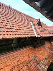 A close up image showcasing the intricate details of a traditional Kerala style tiled roof in Padmanabhapuram palace.