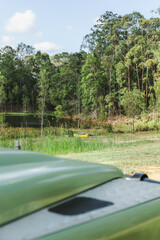 Land Rover Defender at camp with a yellow canoe