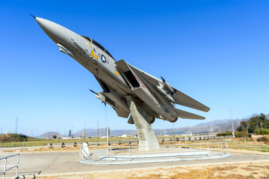 F-14 Tomcat fighter aircraft mounted on a pedestal, angled as if taking off, under a clear blue sky - California, USA - August 26, 2024