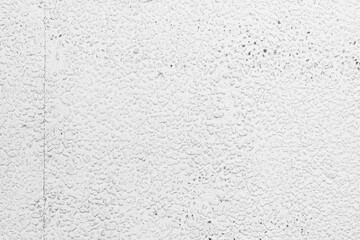 grey and white background with a grungy texture of cement covers the table top, viewed from above, while plaster walls add a dark contrast in the room, creating a calm, bright design overall.