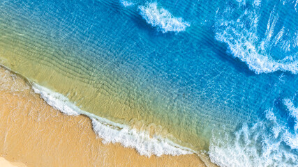 Top view beach sand background for summer vacation concept. Beach nature and summer seawater with sunlight light sandy beach Sparkling sea water