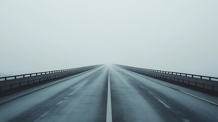 Fototapeta premium A Straight Road Disappears Into Dense Fog