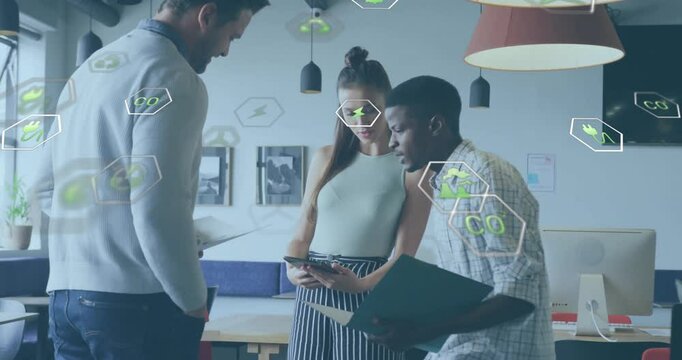 Animation of ecology icons over diverse colleagues discussing work in office