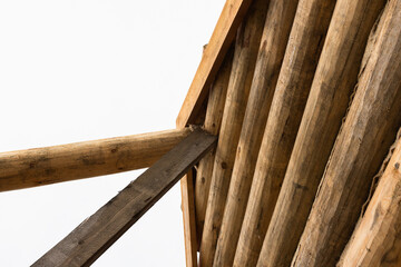 Rural wooden house made of logs is under construction, wooden parts