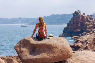 Solo Traveler Admiring the Scenic Coastline of Brittany, France