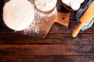 Fresh dough on board with flour