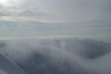 Tranquil Lake With Lush Green Forest, Snow-Capped Mountain, Blue Sky And White Clouds