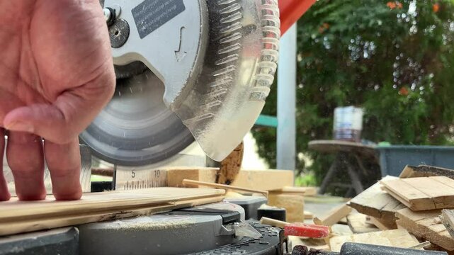 Circular saw for cutting wooden panel made of fiberboard in workshop. Carpenter equipment for Medium Density Fiberboard processing. Woodworking machine with a electric circular saw. Woodworking 