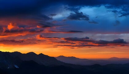 Fototapeta premium The colorful sky with blue and orange hues creates a dramatic backdrop against the silhouetted mountains.