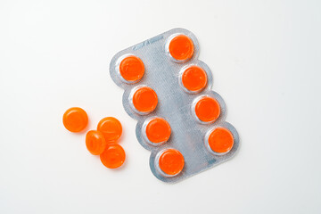 tablets lozenges in a blister pack for coughing in the throat white background