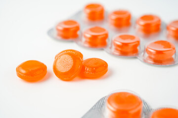 tablets lozenges in a blister pack for coughing in the throat white background