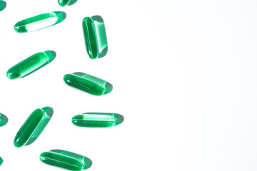 Vitamin E softgel capsules, vitamin D3, fish oil, omega 3, Green oil pills on a white background