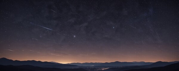 Fototapeta premium A night sky filled with stars and a shooting star streaking across it, with a silhouetted mountain range in the foreground and a city in the distance.