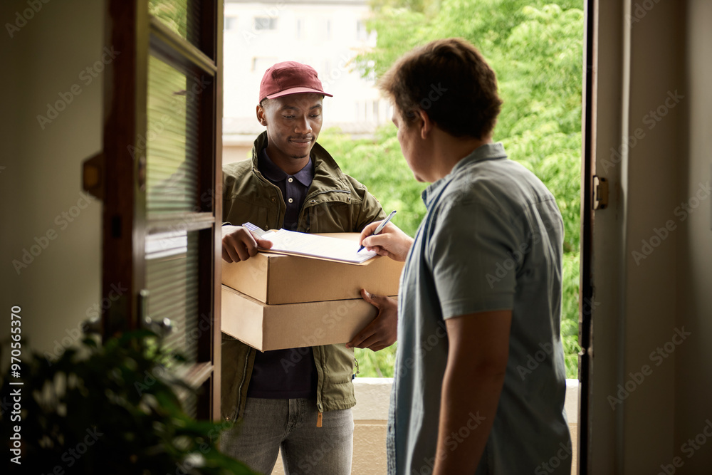 Wall mural man signing for a courier package at his front door