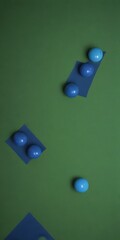 a collection of blue balls scattered across a green background, with some overlapping and others positioned at varying angles.
