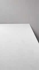 A minimalist image of a white rectangular surface against a gray wall.