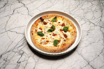 Italian formaggi pizza. Pizza with herbs and cheese on a white plate