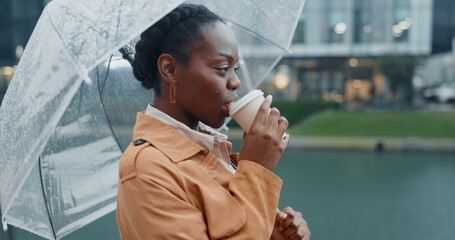 Outside, black woman and smile with umbrella or coffee in rainy weather for commuting or travel to...