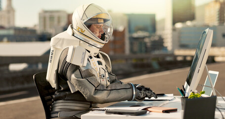 Typing, city and astronaut with computer in road for business project with interstellar report for mission. Tech, person and space pilot at desk working on discovery of civilization on bridge in town © HockleyM3/peopleimages.com