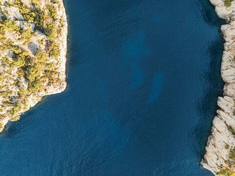 Aerial view of long narrow canyon deep into the landscape at sunrise. Cassis, France