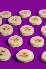 Banana slices on a purple surface