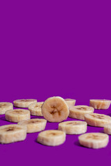 Banana slices on a purple surface