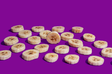 Banana slices on a purple surface