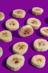 Banana slices on a purple surface