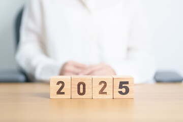 2025 year calendar block on table. goal, Resolution, strategy, plan, start, budget, mission,...
