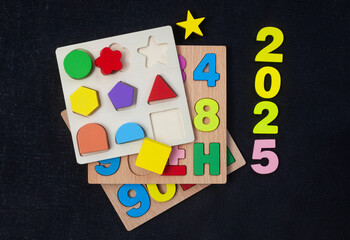 Children’s educational puzzles with the numbers 2025 for the new year ahead.
On textured black with copy space
