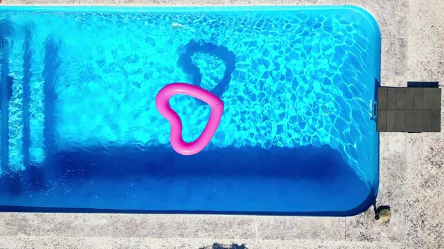Seen from above a heart shaped buoy in a pool