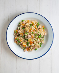 Brown rice with vegetables and turkey cubes. Top view.
