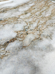 Top view photo of white soap lying on the bathroom floor with shampoo foam on terrazzo tiles. Round soap in the bathroom full of foam in conceptual art.