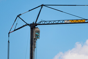 Obraz premium Construction crane against blue sky.
