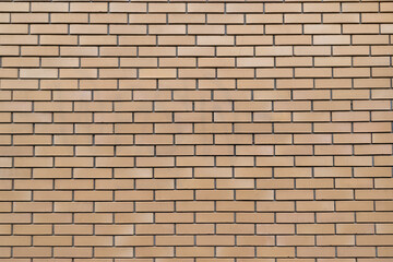 Seamless beige brick wall texture with horizontal rectangular bricks.