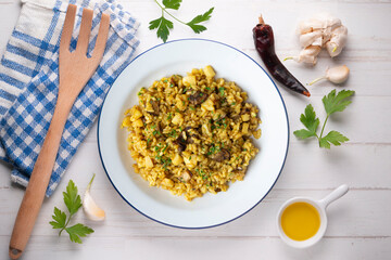 Arroz a banda. Rice paella with cuttlefish. Top view table.