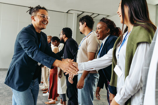 Business professionals shaking hands and networking in an office setting