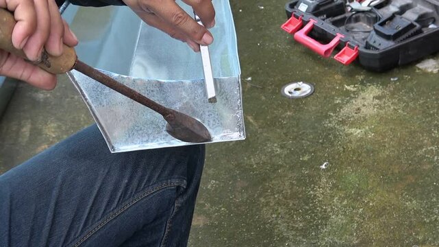 Technician solders gutters for customers.