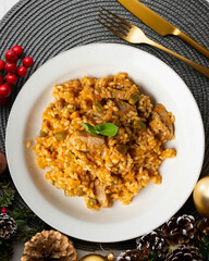 Rice paella with pork loin and green beans. Top view table with christmas decoration.